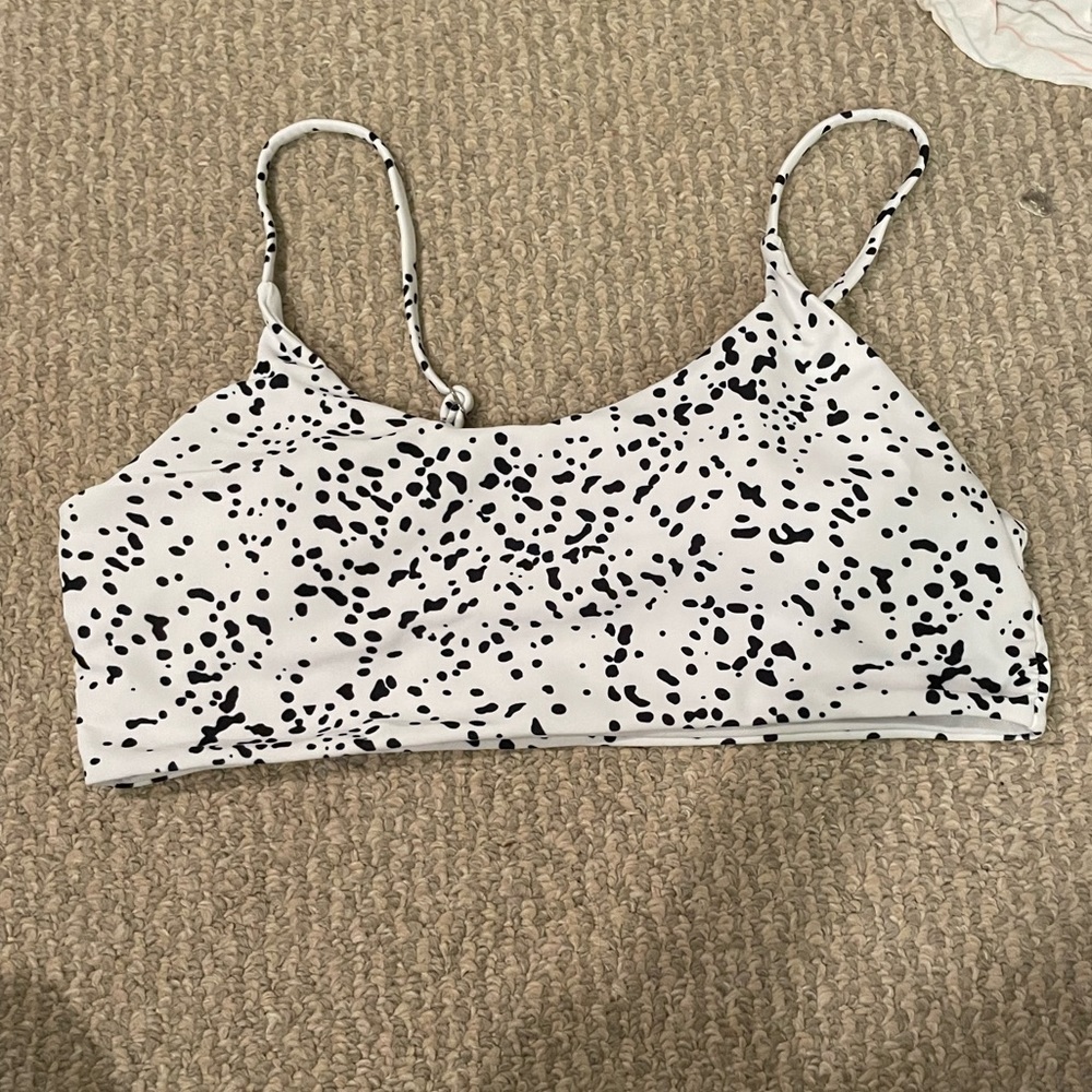Black and white polka dot swimsuit top.